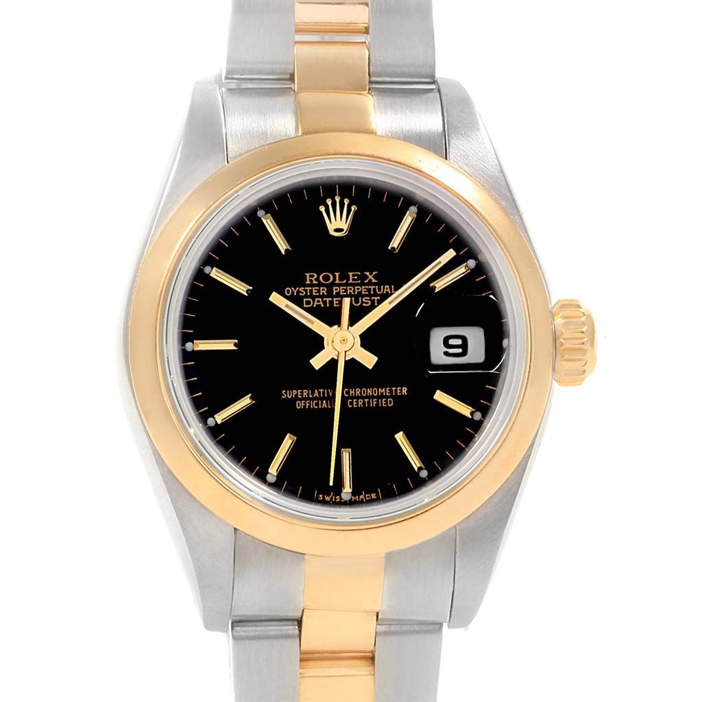 The image shows a front view of a Rolex Datejust 79163 Women's Steel and Gold (two tone) Black Dial 79163 Women's Steel and Gold (two tone) Black Dial watch, featuring its black dial, gold bezel, and two-tone bracelet.