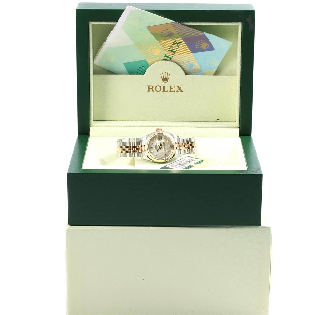 The image shows a Rolex Datejust 179173 Women's Steel and Gold (two tone) Mother of Pearl Dial 179173 Women's Steel and Gold (two tone) Mother of Pearl Dial watch inside an open Rolex box with booklets tucked in the lid.