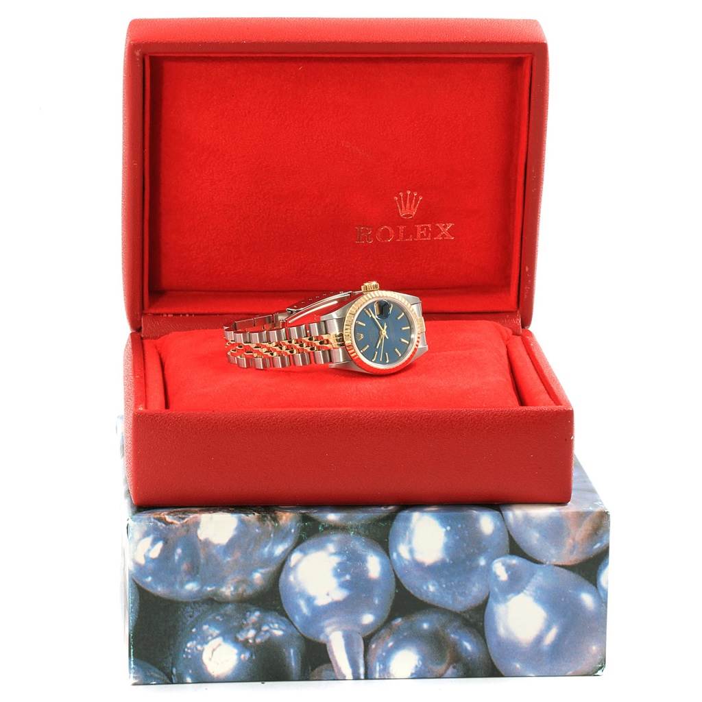 A Rolex Datejust 69173 Women's Steel and Gold (two tone) Blue Dial 69173 Women's Steel and Gold (two tone) Blue Dial watch in a red presentation box, showing the face and bracelet at a slight angle.