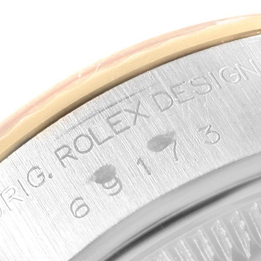 The image shows a close-up view of the serial number engraving on the case back of a Rolex Datejust 69173 Women's Steel and Gold (two tone) Blue Dial 69173 Women's Steel and Gold (two tone) Blue Dial watch.