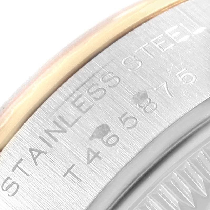 The image shows a close-up of the bezel and part of the case back of a Rolex Datejust 69173 Women's Steel and Gold (two tone) Blue Dial 69173 Women's Steel and Gold (two tone) Blue Dial watch, highlighting the engraving.