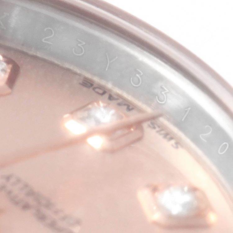 This close-up image shows the dial and part of the bezel of a Rolex Datejust 179171 Women
s Steel and Gold (two tone) Pink Dial 179171 Women
s Steel and Gold (two tone) Pink Dial watch.
