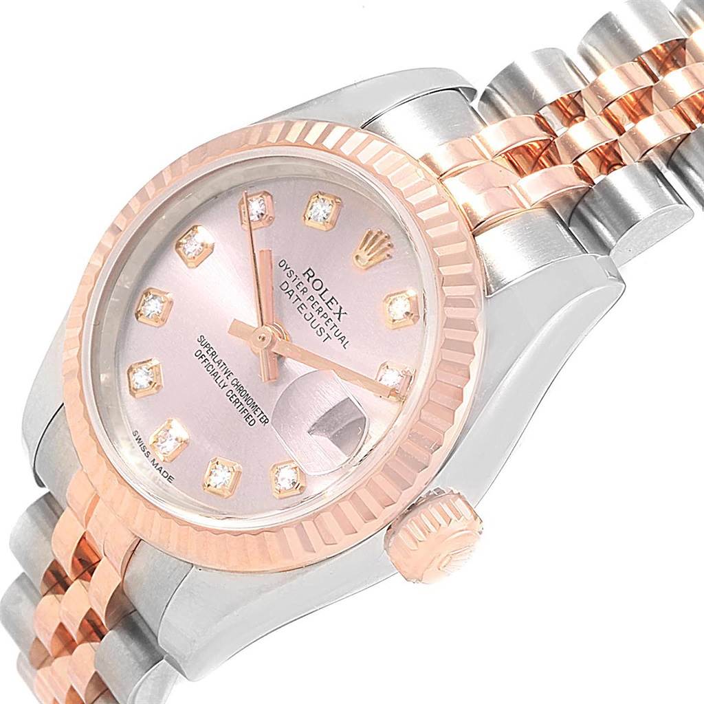 The image shows a close-up angled view of the dial, bezel, crown, and part of the bracelet of a Rolex Datejust 179171 Women
s Steel and Gold (two tone) Pink Dial 179171 Women
s Steel and Gold (two tone) Pink Dial watch.
