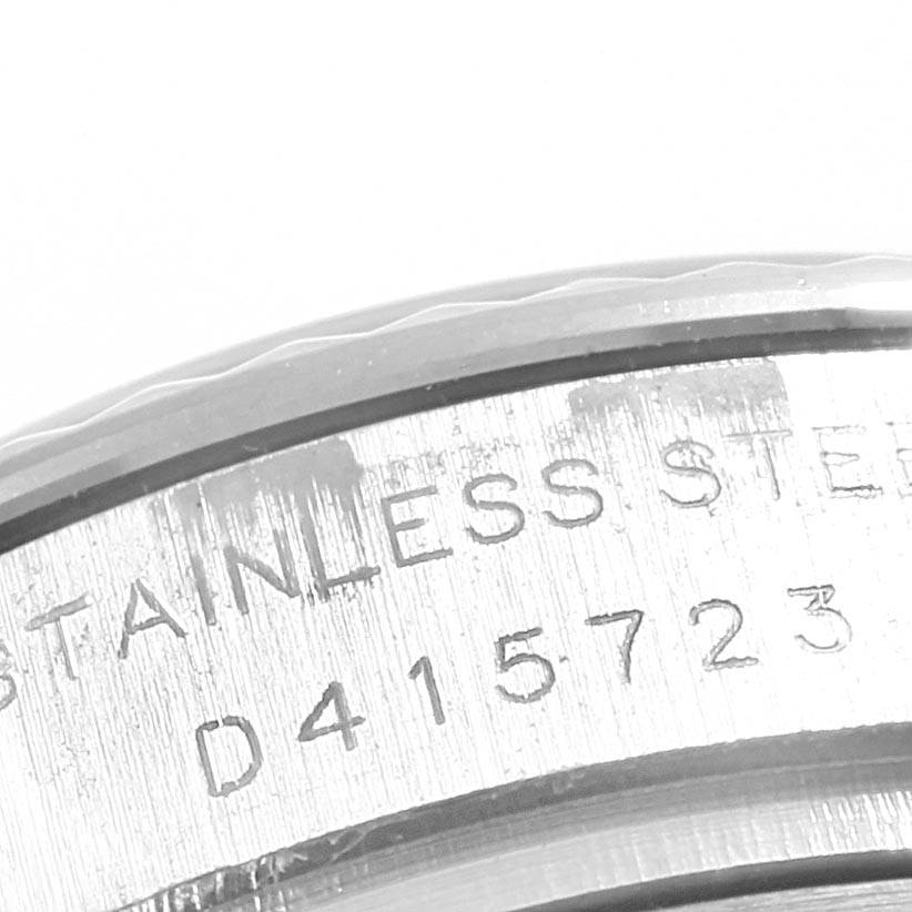 The image shows a close-up view of the serial number engraving on the side of a Rolex Datejust 179174 Women's Steel and Gold (two tone) Silver Dial 179174 Women's Steel and Gold (two tone) Silver Dial stainless steel watch case.
