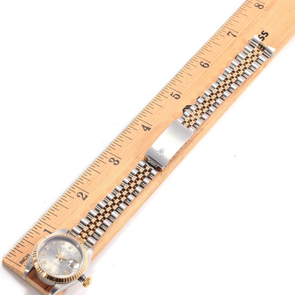 The Rolex Datejust 69173 Women's Stainless Steel Grey Dial 69173 Women's Stainless Steel Grey Dial watch is shown from an overhead angle, displaying its face and entire bracelet alongside a ruler for scale.