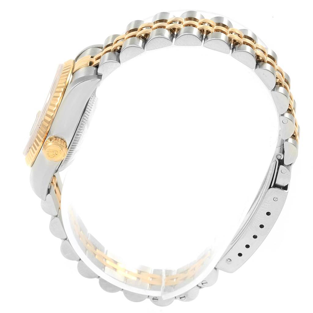 This image shows a side view of the Rolex Datejust 69173 Women's Stainless Steel Grey Dial 69173 Women's Stainless Steel Grey Dial watch focusing on the gold and silver bracelet and the crown.