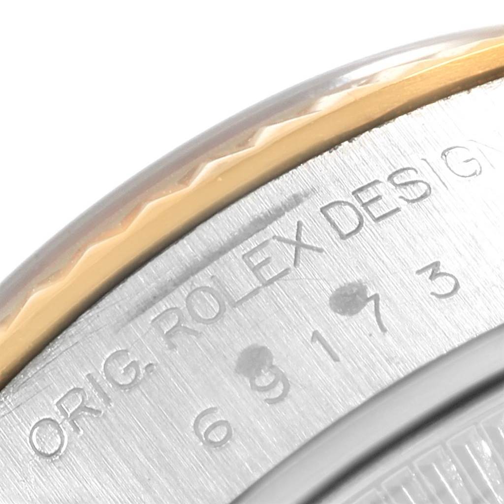 The image shows a close-up of the bezel and case back of a Rolex Datejust 69173 Women's Stainless Steel Grey Dial 69173 Women's Stainless Steel Grey Dial watch, highlighting the engraved markings.