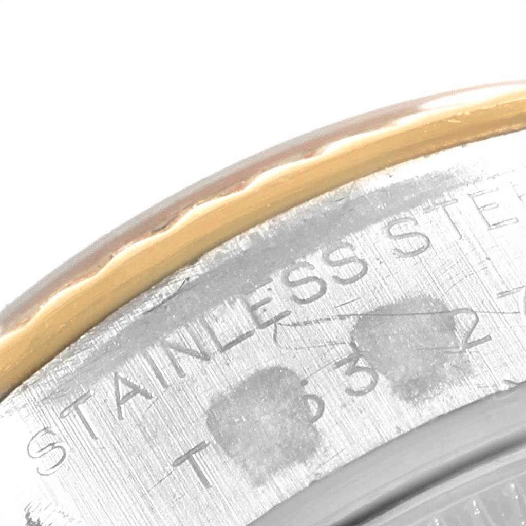 The image shows a close-up of the edge of a Rolex Datejust 69173 Women
s Stainless Steel Beige Dial 69173 Women
s Stainless Steel Beige Dial watch, highlighting part of the bezel and the "STAINLESS STEEL" engraving.