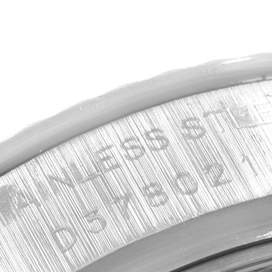 The image shows a close-up of the engraved serial number and "STAINLESS STEEL" text on the caseback of a Rolex Datejust 179174 Women
s Stainless Steel Silver Dial 179174 Women
s Stainless Steel Silver Dial watch.