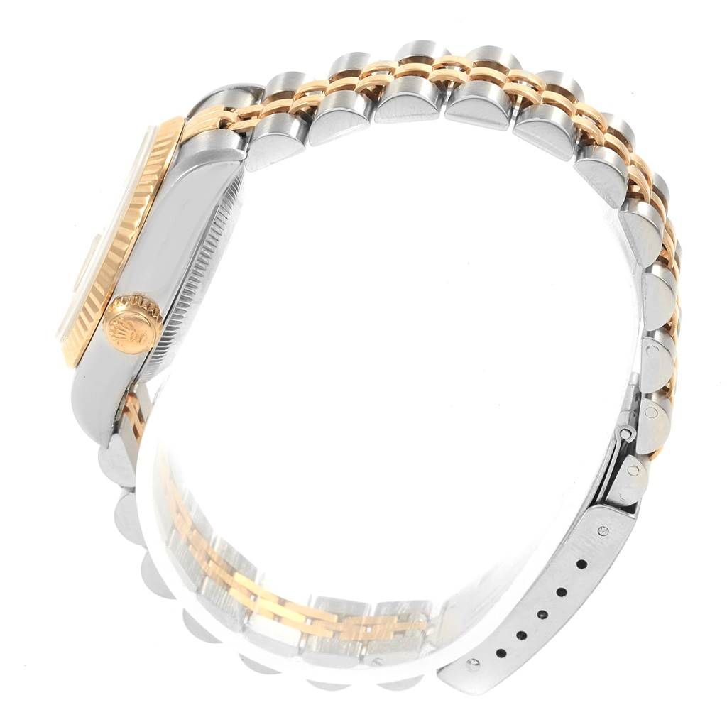 The image shows a side and partial profile view of a Rolex Datejust 69173 Women's Stainless Steel Beige Dial 69173 Women's Stainless Steel Beige Dial watch, focusing on the case, crown, fluted bezel, and two-tone bracelet.