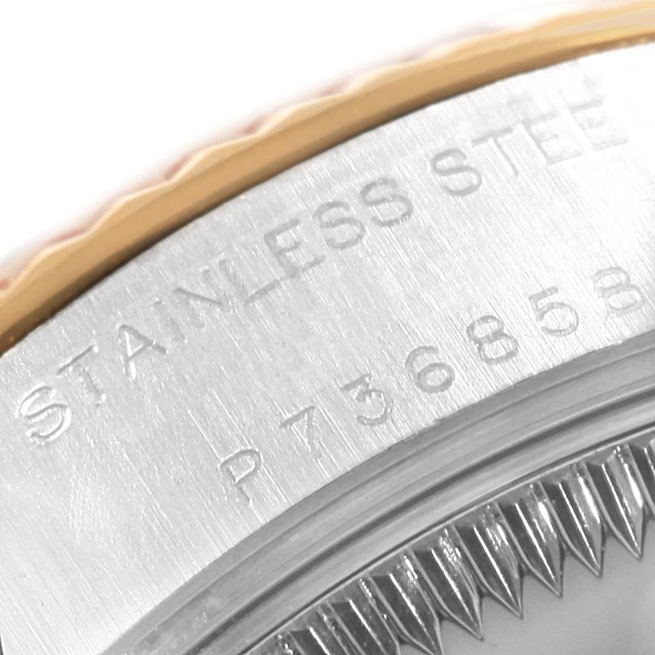 This is a close-up of the case back of a Rolex Datejust 79173 Women's Steel and Gold (two tone) White Dial 79173 Women's Steel and Gold (two tone) White Dial watch, displaying part of the serial number and the fluted bezel.