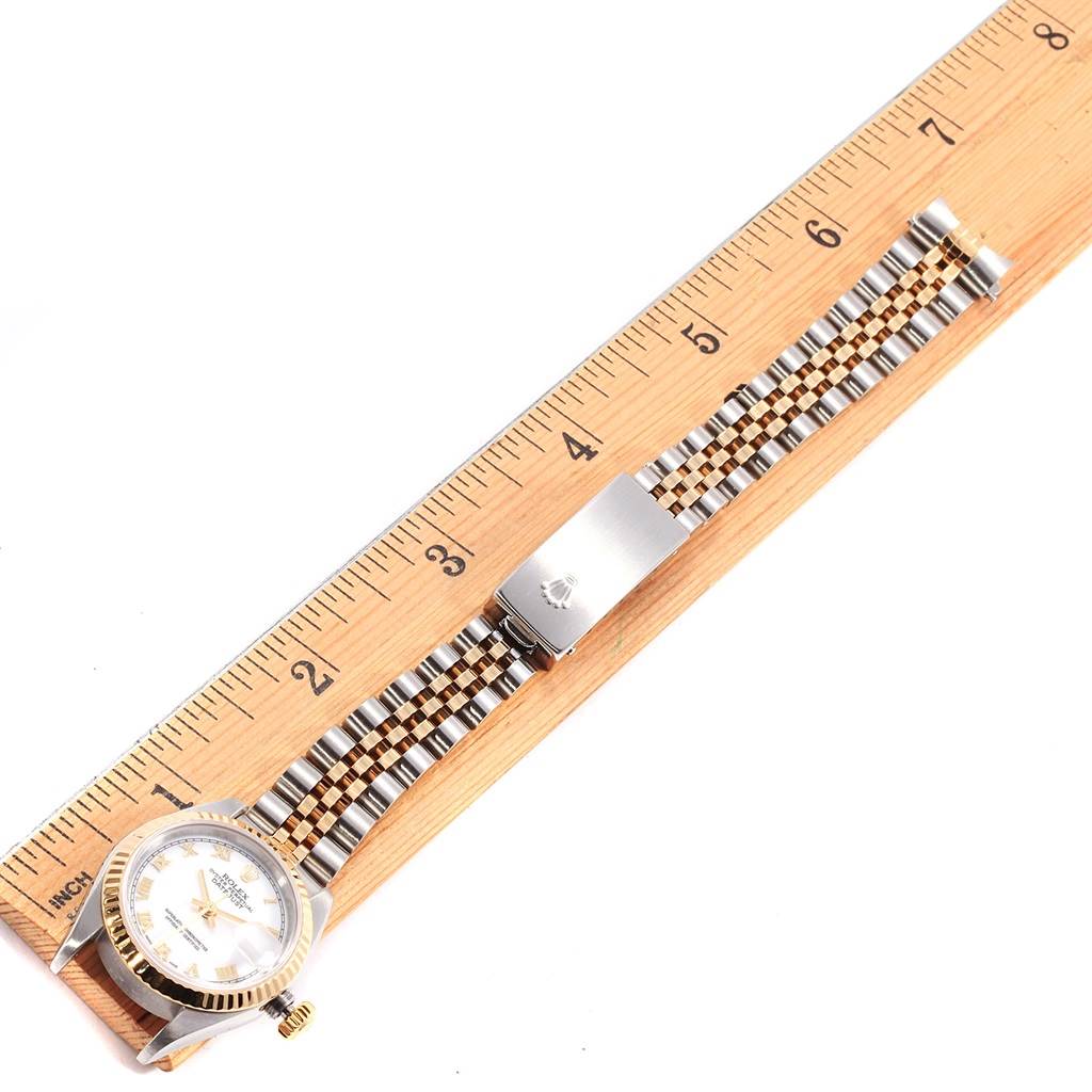 The image shows a Rolex Datejust 79173 Women's Steel and Gold (two tone) White Dial 79173 Women's Steel and Gold (two tone) White Dial watch laying flat with its bracelet fully extended along a ruler.