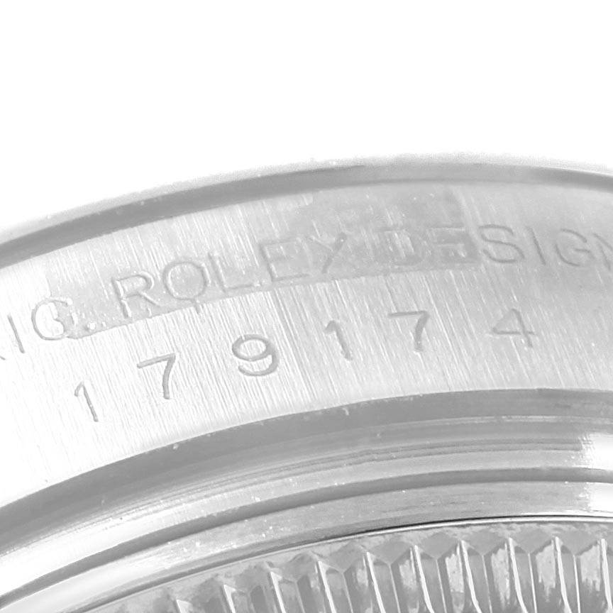 This is a close-up angle showing the engraved serial number on the bezel and part of the case of a Rolex Datejust 179174 Women
s Stainless Steel Silver Dial 179174 Women
s Stainless Steel Silver Dial watch.