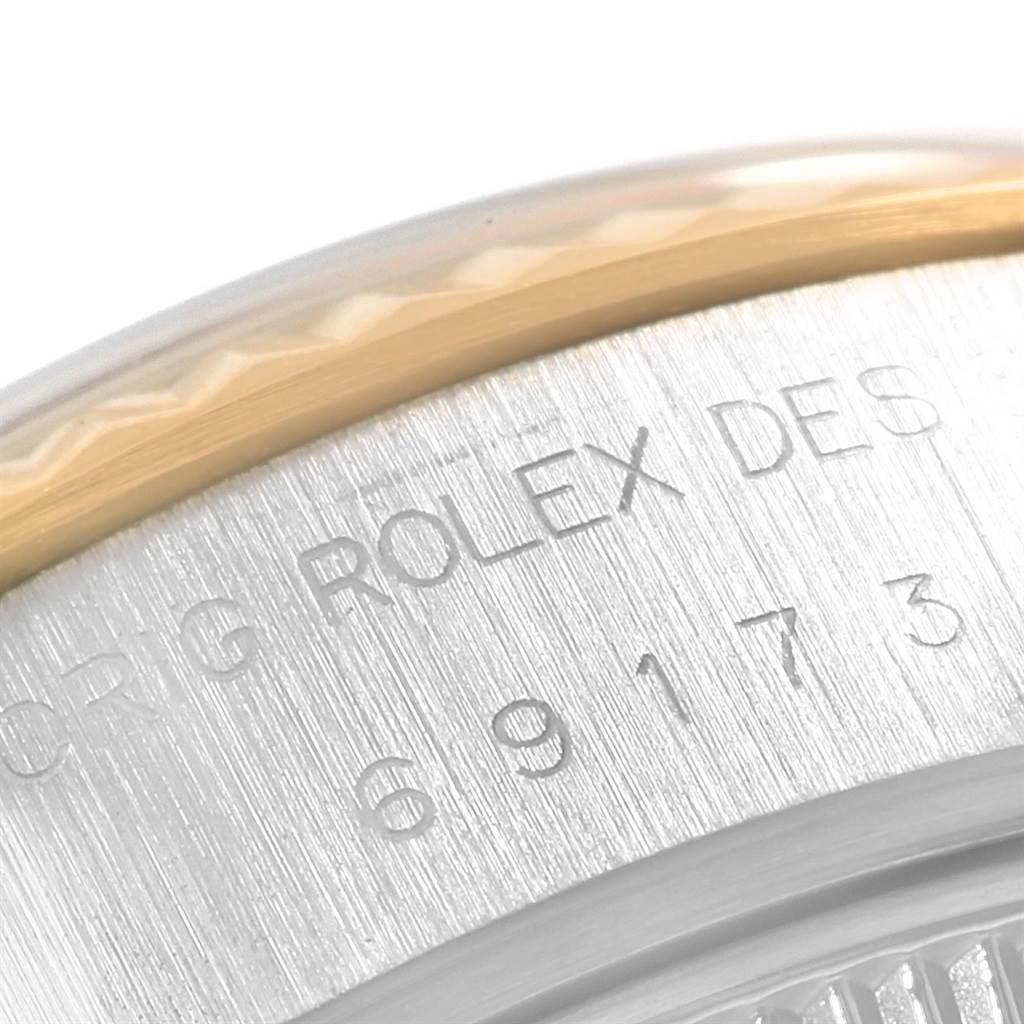 This close-up image shows the engraved case back and part of the bezel of a Rolex Datejust 69173 Women
s Stainless Steel Silver Dial 69173 Women
s Stainless Steel Silver Dial watch.