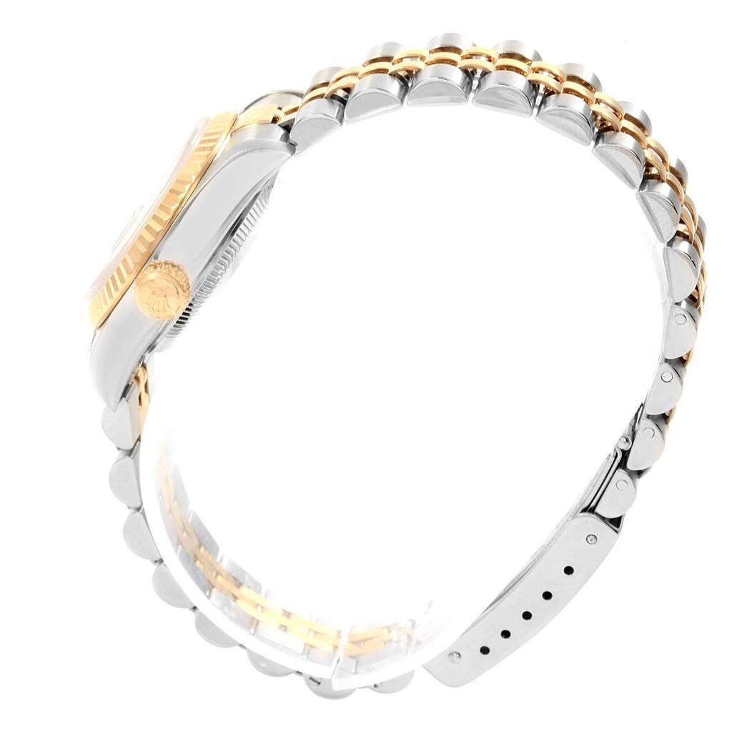 The Rolex Datejust 79173 Women's Steel and Gold (two tone) Grey Dial 79173 Women's Steel and Gold (two tone) Grey Dial watch is shown from a side angle, highlighting the crown, bezel, and bracelet.