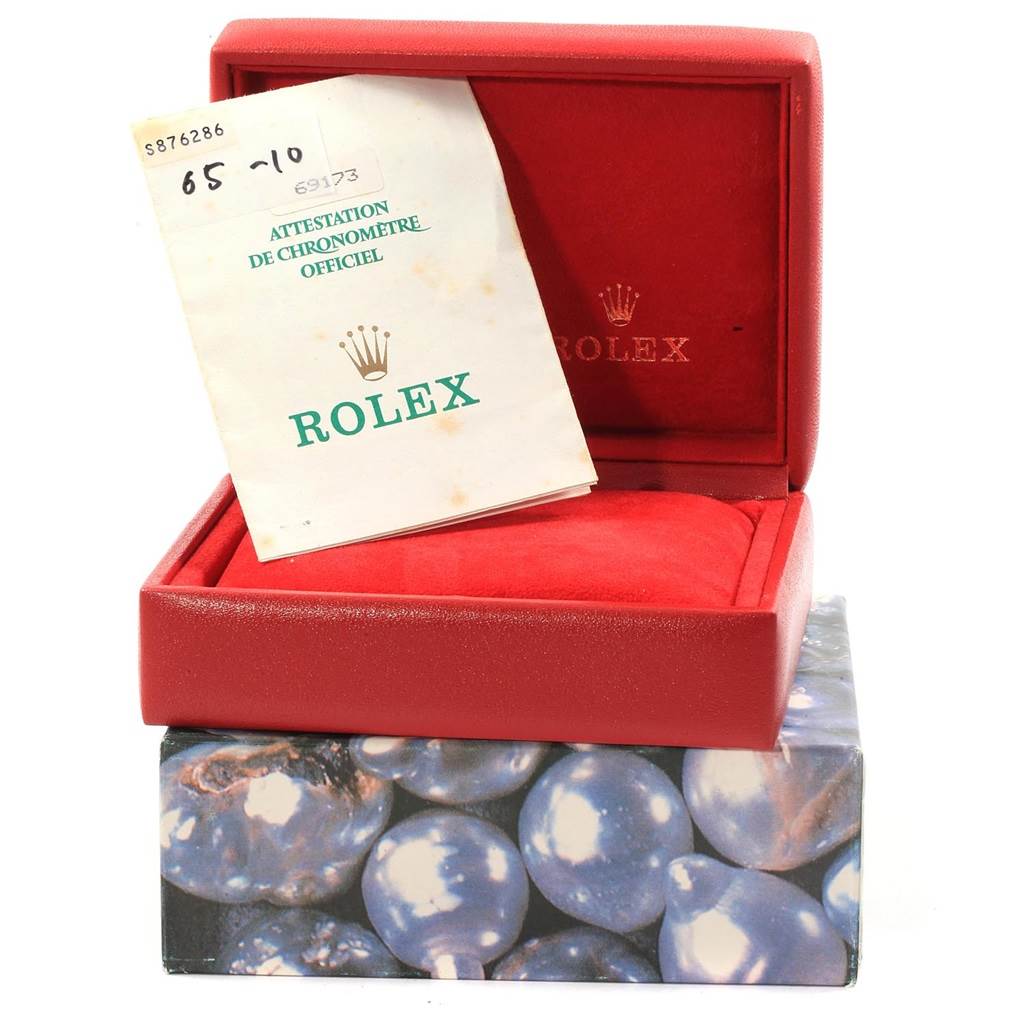 The image shows an open red Rolex Datejust 69173 Women's Stainless Steel Beige Dial 69173 Women's Stainless Steel Beige Dial watch box with a booklet placed inside.