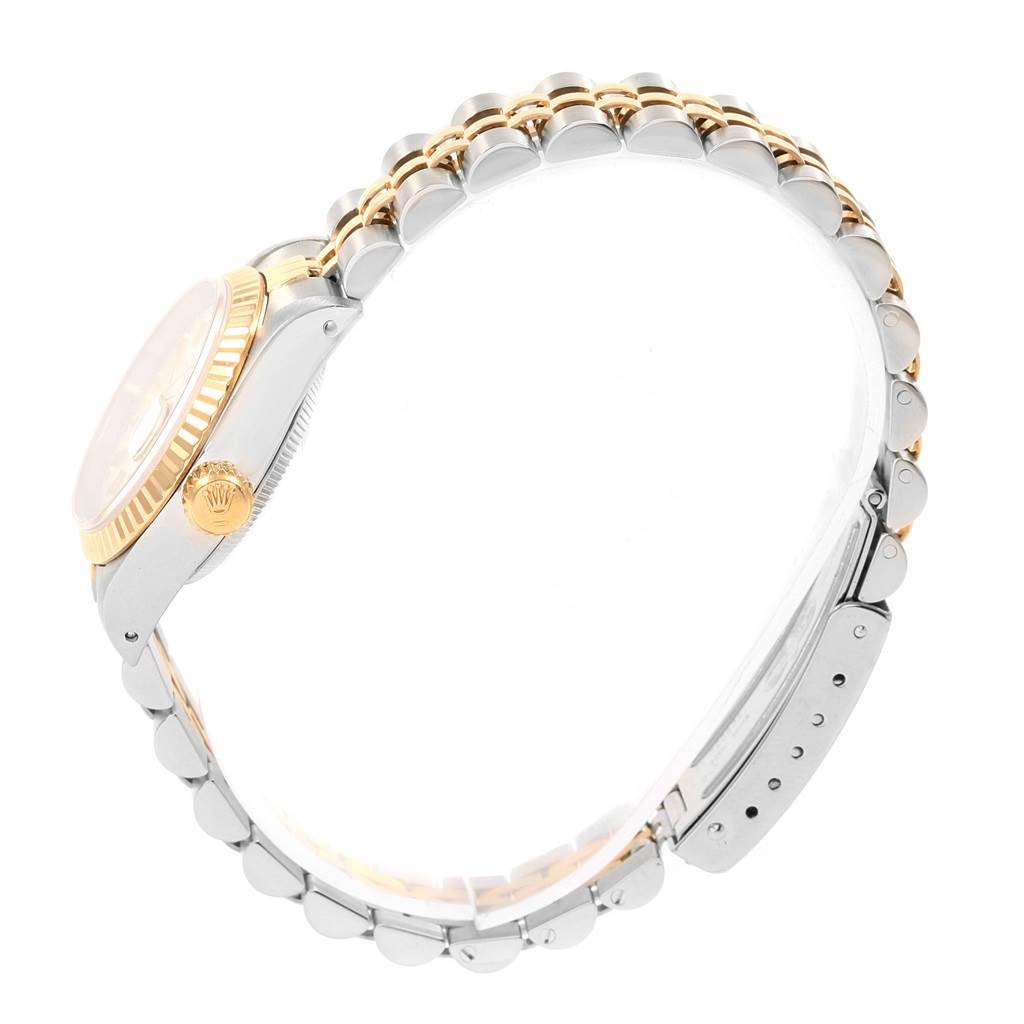 This side view image of a Rolex Datejust 69173 Women's Stainless Steel Silver Dial 69173 Women's Stainless Steel Silver Dial watch shows the crown, case, and metal bracelet with a two-tone design.