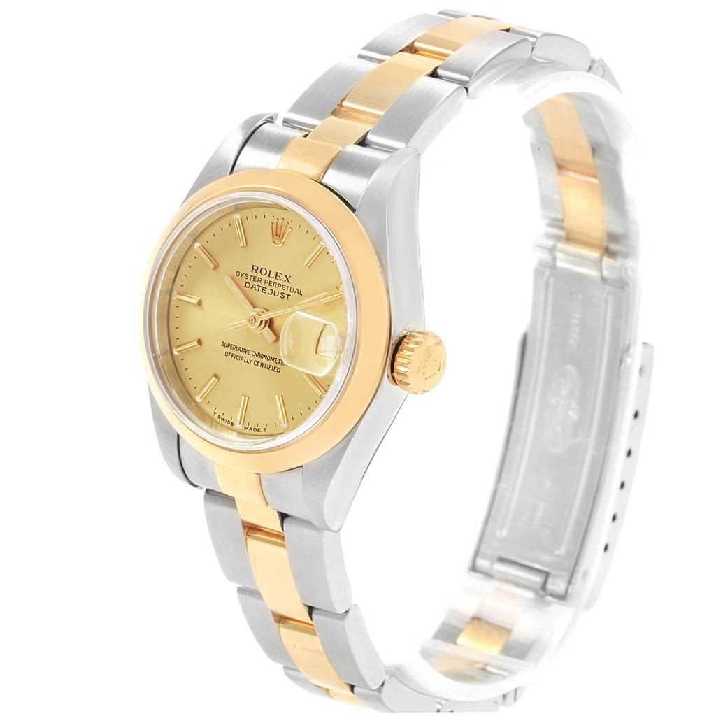 The Rolex Datejust 69163 Women's Stainless Steel Champagne Dial 69163 Women's Stainless Steel Champagne Dial watch is shown at an angle displaying its gold and silver bracelet, face, crown, and part of the clasp.