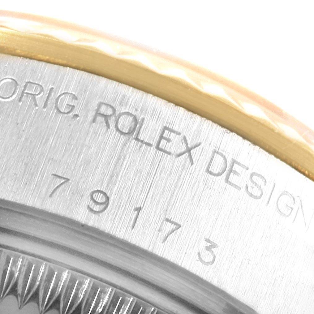 This close-up image shows the engraved case back and bezel details of a Rolex Datejust 69173 Women's Stainless Steel Beige Dial 69173 Women's Stainless Steel Beige Dial watch.