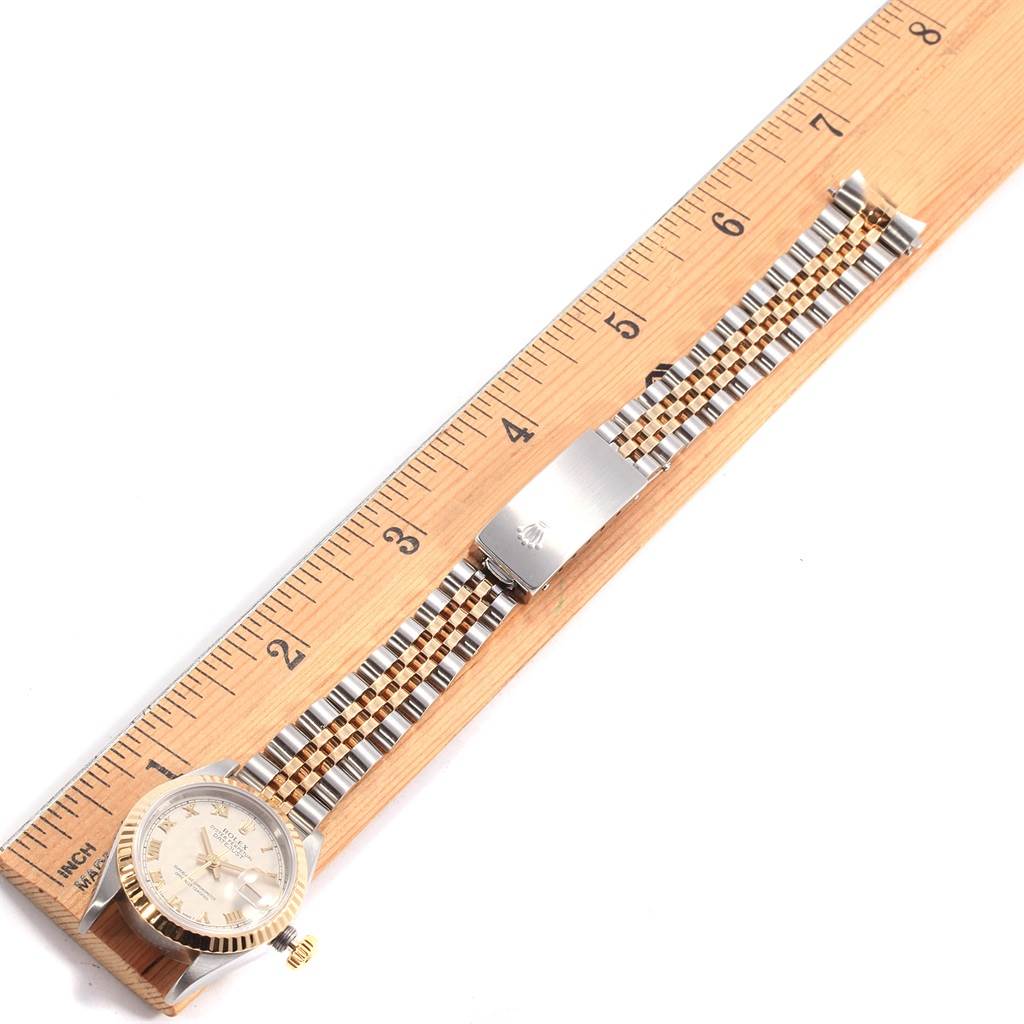 This image shows a Rolex Datejust 69173 Women's Stainless Steel Beige Dial 69173 Women's Stainless Steel Beige Dial watch laid flat next to a ruler, with its dial and bracelet clasp clearly visible.