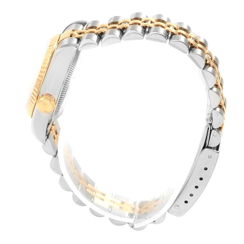 This side angle view of the Rolex Datejust 69173 Women's Stainless Steel Beige Dial 69173 Women's Stainless Steel Beige Dial watch shows the two-tone bracelet, case side, and crown.