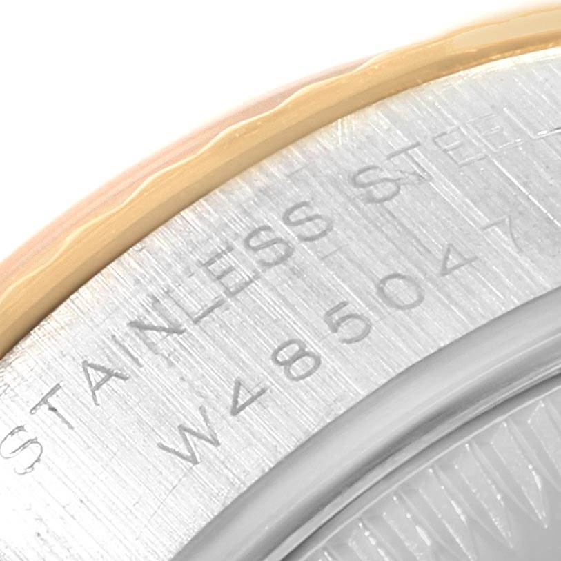 This close-up angle shows part of the back casing and the bezel of the Rolex Datejust 69173 Women's Stainless Steel Beige Dial 69173 Women's Stainless Steel Beige Dial, highlighting the "STAINLESS STEEL" engraving.