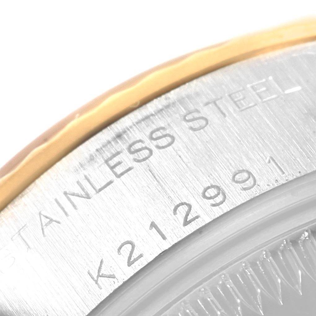 This image shows a close-up of the case back edge of a Rolex Datejust 79173 Women's Steel and Gold (two tone) White Dial 79173 Women's Steel and Gold (two tone) White Dial, revealing the stainless steel and partial serial number.
