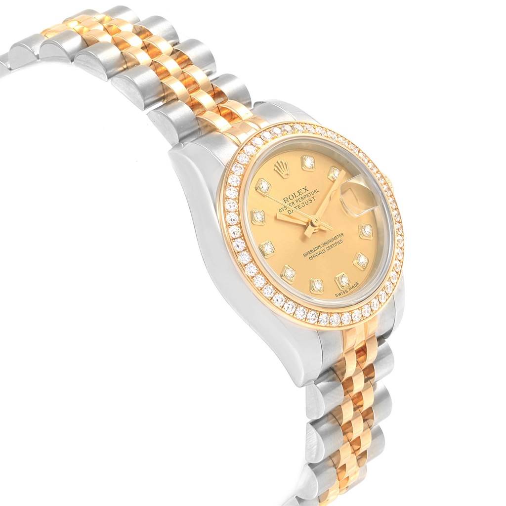 The image shows a Rolex Datejust 179383 Women's Steel and Gold (two tone) Champagne Dial 179383 Women's Steel and Gold (two tone) Champagne Dial watch from an angled side view, highlighting its gold dial, diamond bezel, and two-tone bracelet.
