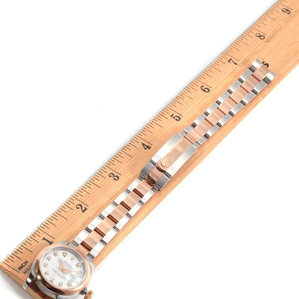 The image shows a Rolex Datejust 179161 Women's Steel and Gold (two tone) White Dial 179161 Women's Steel and Gold (two tone) White Dial watch laid flat alongside a ruler, highlighting the full length and bracelet details.