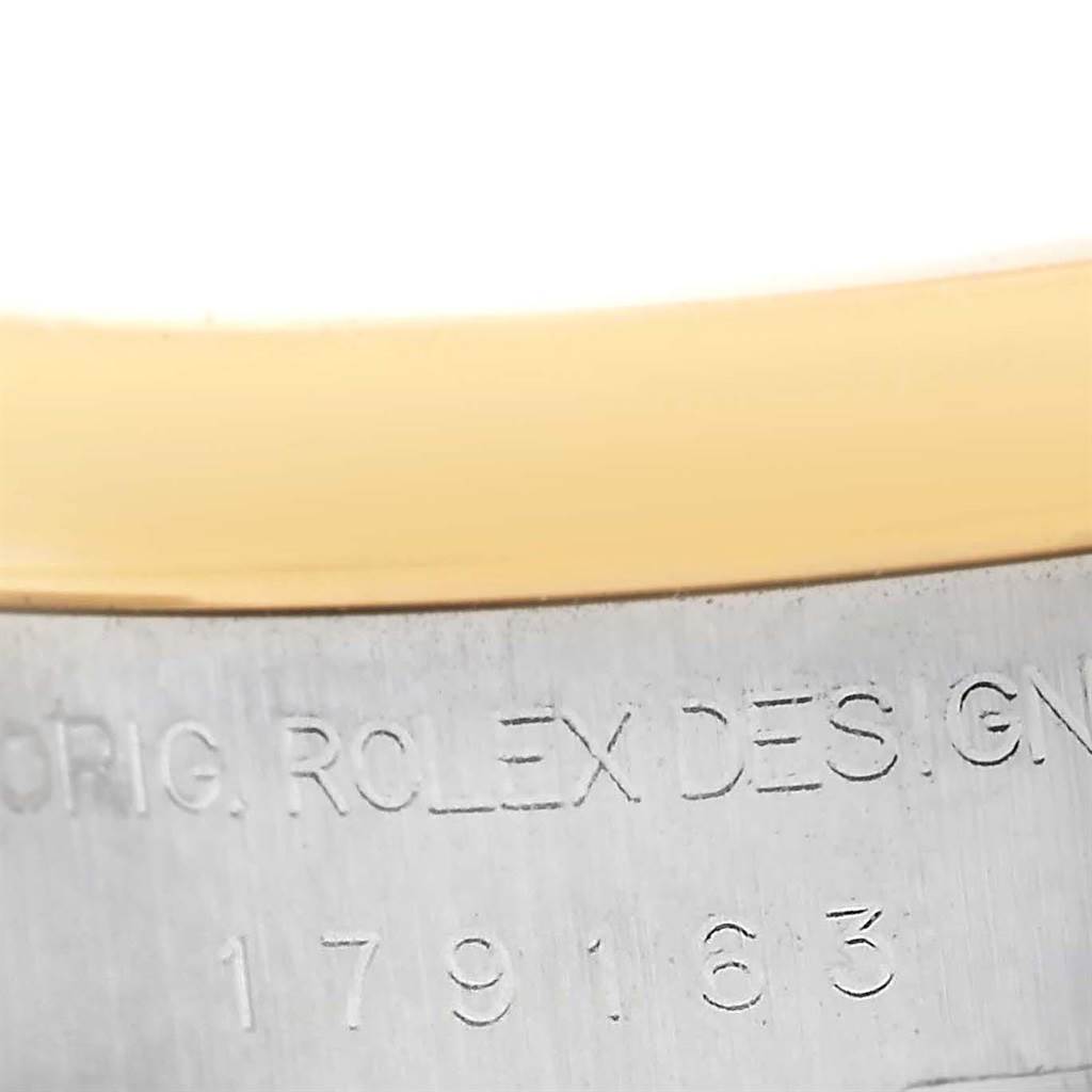 This close-up image shows the model number and part of the bezel of a Rolex Datejust 179163 Women's Steel and Gold (two tone) White Dial 179163 Women's Steel and Gold (two tone) White Dial watch.