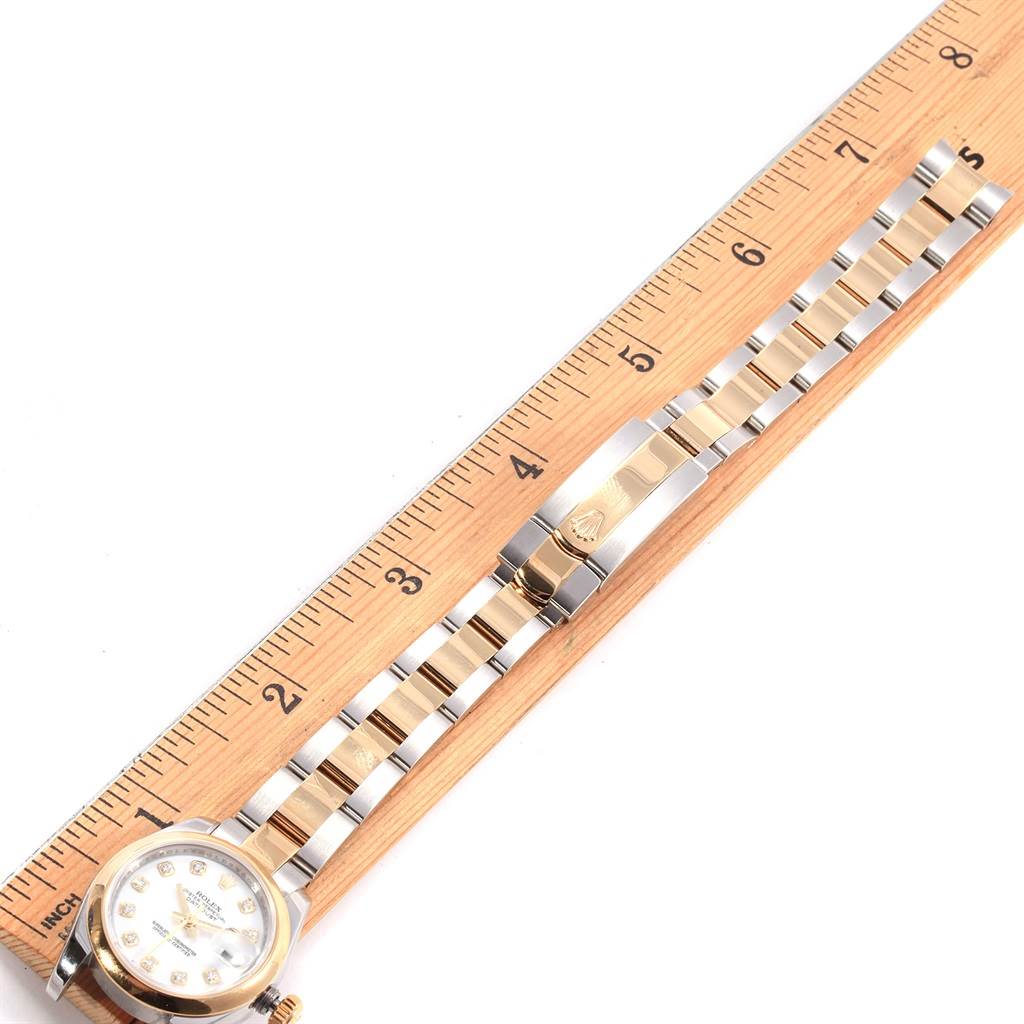 The image shows a full view of a Rolex Datejust 179163 Women's Steel and Gold (two tone) White Dial 179163 Women's Steel and Gold (two tone) White Dial watch with the clasp and bracelet measured against a ruler.