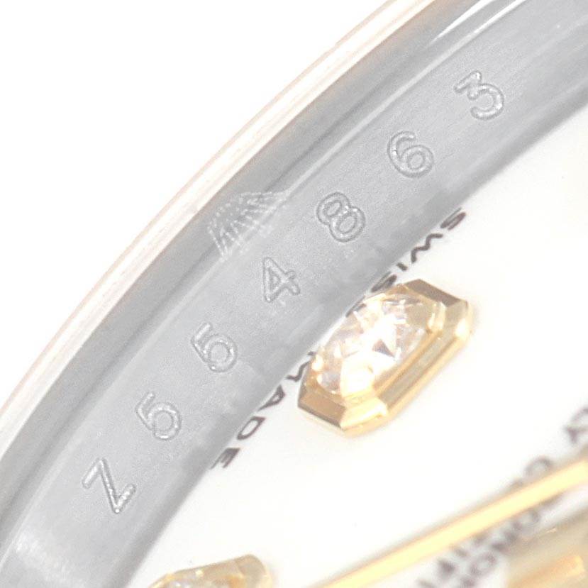 The image shows a close-up of the serial number engraving on the rehaut and part of the diamond hour marker of a Rolex Datejust 179163 Women's Steel and Gold (two tone) White Dial 179163 Women's Steel and Gold (two tone) White Dial watch.