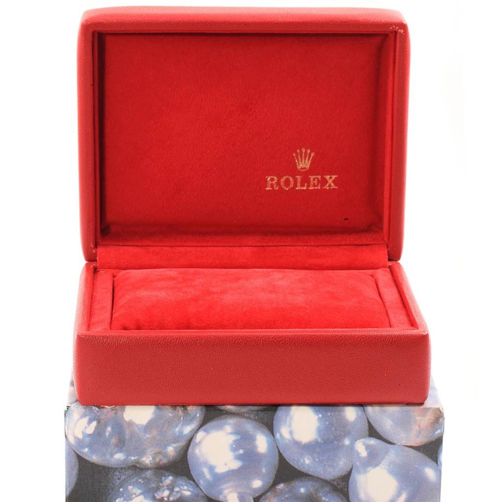 A red Rolex watch box for the Datejust model is shown open from the front angle, displaying the inner cushion and interior branding.