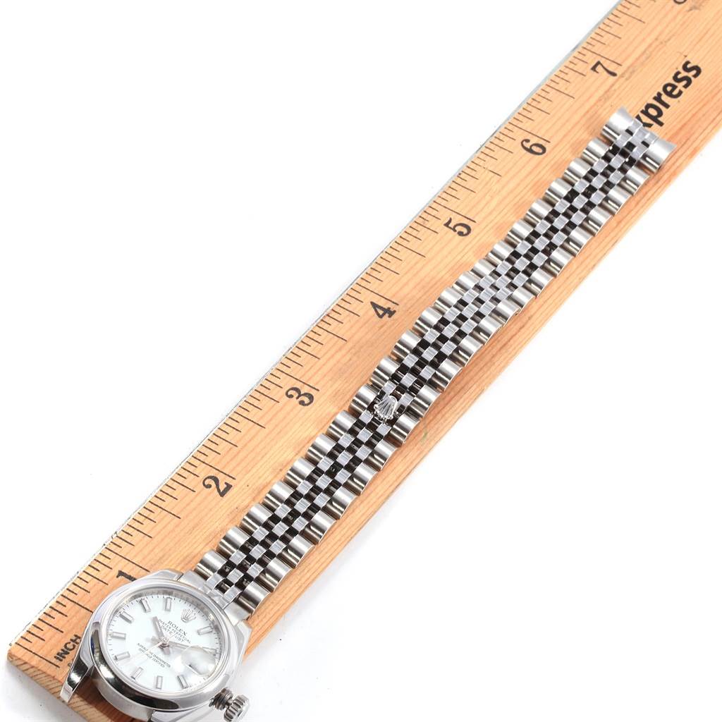 This image shows a full view of the Rolex Datejust 179160 Women's Stainless Steel White Dial 179160 Women's Stainless Steel White Dial watch lying flat next to a ruler, highlighting its face and bracelet.