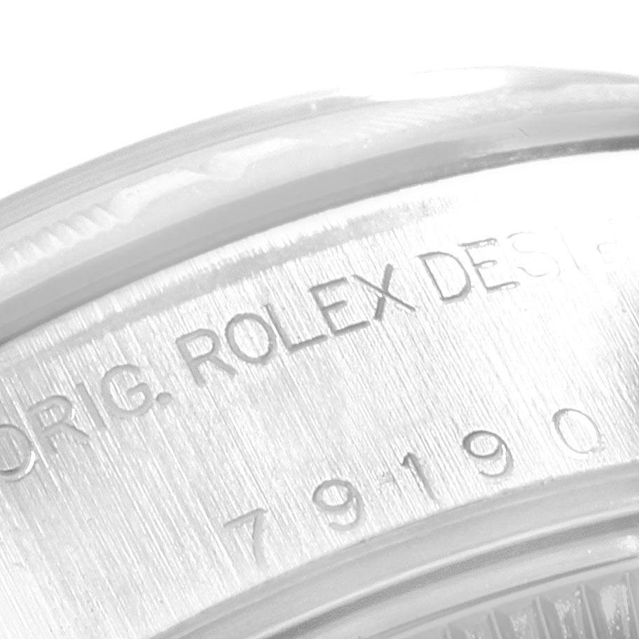 This image shows a close-up of the engraved inner case back of a Rolex Datejust 79190 Women's Stainless Steel White Dial 79190 Women's Stainless Steel White Dial watch.
