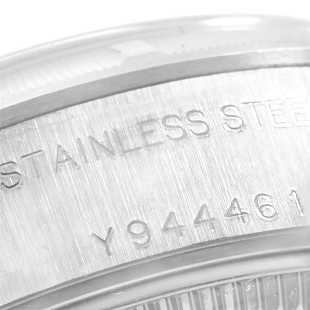 This close-up image shows the serial number and "STAINLESS STEEL" engraving on the case of a Rolex Datejust 79190 Women's Stainless Steel White Dial 79190 Women's Stainless Steel White Dial watch.
