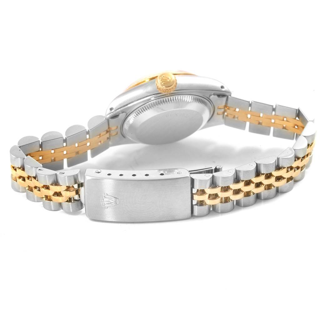 This Rolex Datejust 69173 Women
s Stainless Steel Beige Dial 69173 Women
s Stainless Steel Beige Dial watch is shown from the back, highlighting the case back, crown, and two-tone bracelet.