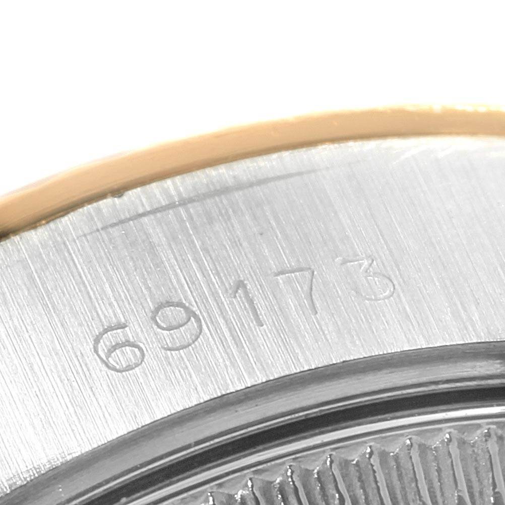 The image shows a close-up of the serial number engraved on the case back of a Rolex Datejust 69173 Women
s Stainless Steel Beige Dial 69173 Women
s Stainless Steel Beige Dial watch.