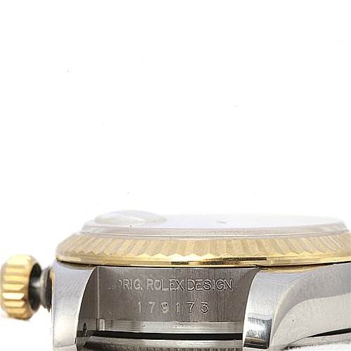 The image shows a side view of a Rolex Datejust 179173 Women's Stainless Steel White Dial 179173 Women's Stainless Steel White Dial watch case, highlighting the crown, fluted bezel, and engraved serial number.