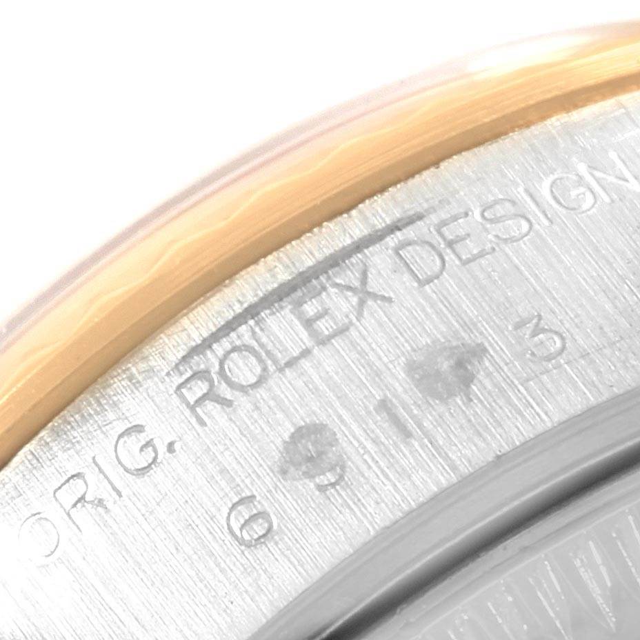 This is a close-up image of the back casing of a Rolex Datejust 69173 Women's Stainless Steel Black Dial 69173 Women's Stainless Steel Black Dial watch, showing part of the "ROLEX DESIGN" engraving.