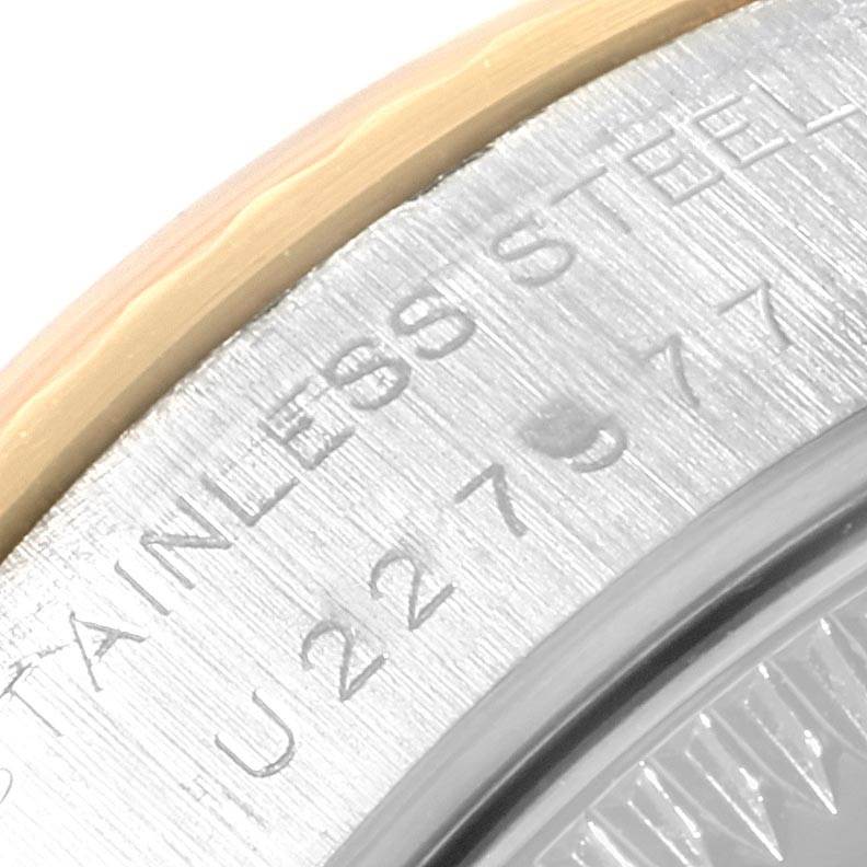 This zoomed-in image shows part of the case back and edge of a Rolex Datejust 69173 Women's Stainless Steel Black Dial 69173 Women's Stainless Steel Black Dial watch, with "STAINLESS STEEL" engraved.