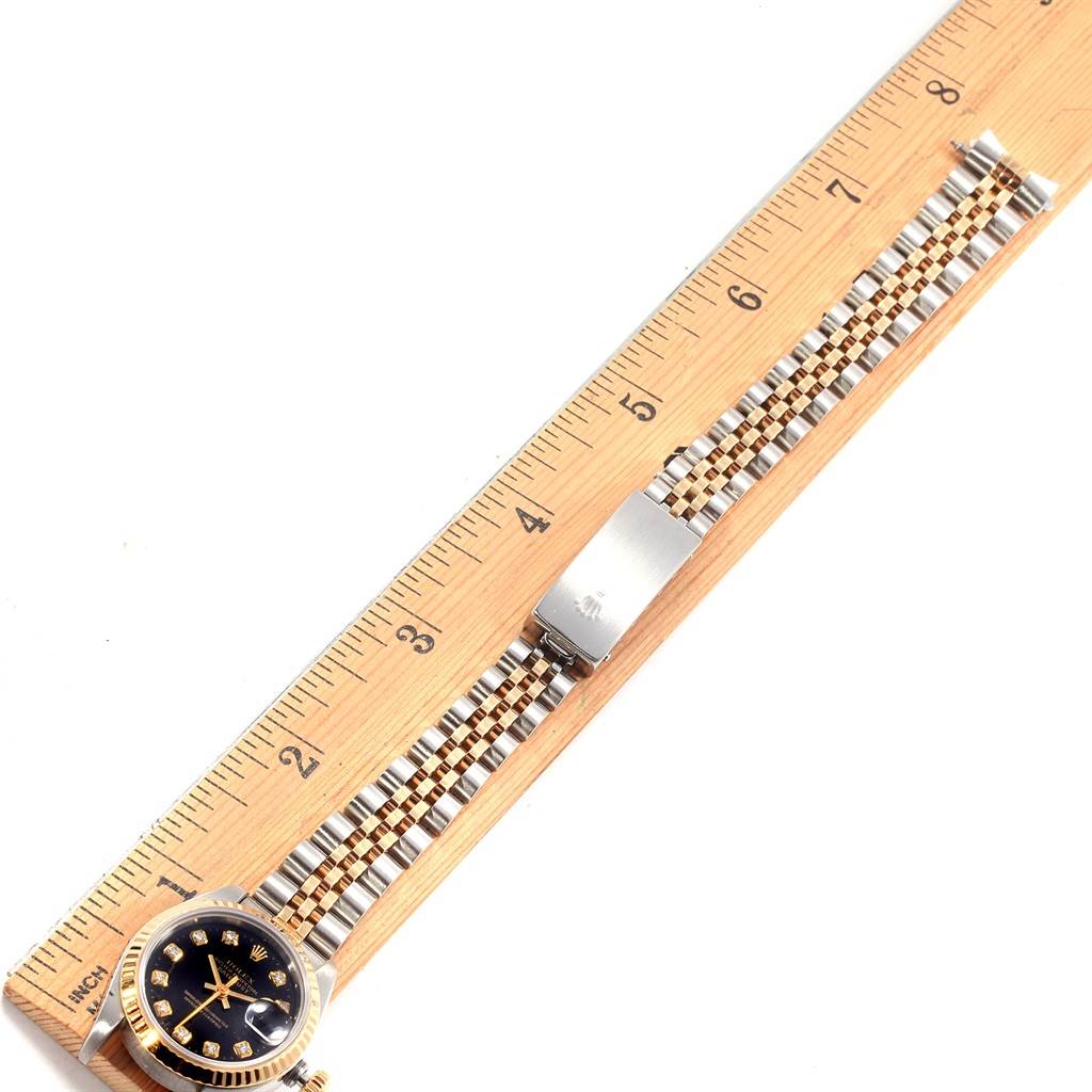 The image shows the Rolex Datejust 69173 Women's Stainless Steel Black Dial 69173 Women's Stainless Steel Black Dial watch with a Jubilee bracelet, measured alongside a ruler laid flat.