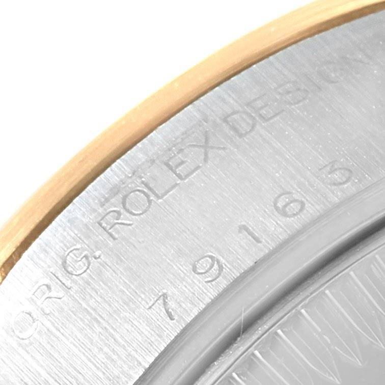 The image shows a close-up of the engraved edge, showing the serial number and branding of the Rolex Datejust 79163 Women's Steel and Gold (two tone) Silver Dial 79163 Women's Steel and Gold (two tone) Silver Dial watch.