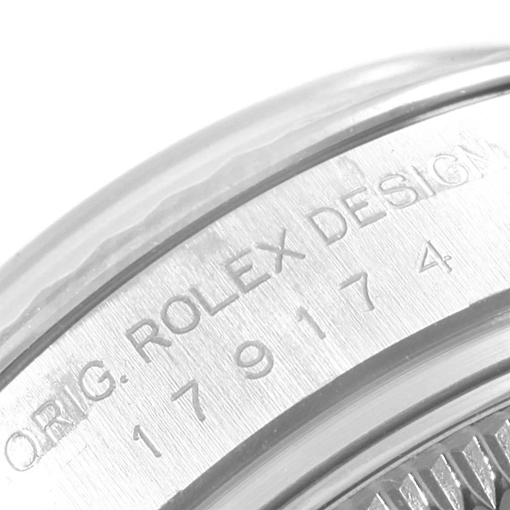This is a macro shot of the side case and bezel of a Rolex Datejust 179174 Women's Stainless Steel Silver Dial 179174 Women's Stainless Steel Silver Dial watch.