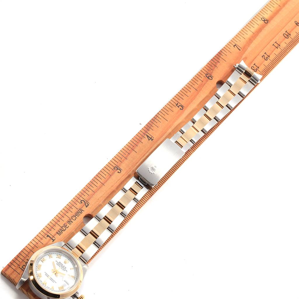 The image shows a Rolex Datejust 69163 Women's Steel and Gold (two tone) White Dial 69163 Women's Steel and Gold (two tone) White Dial watch lying flat with its bracelet extended alongside a wooden ruler.