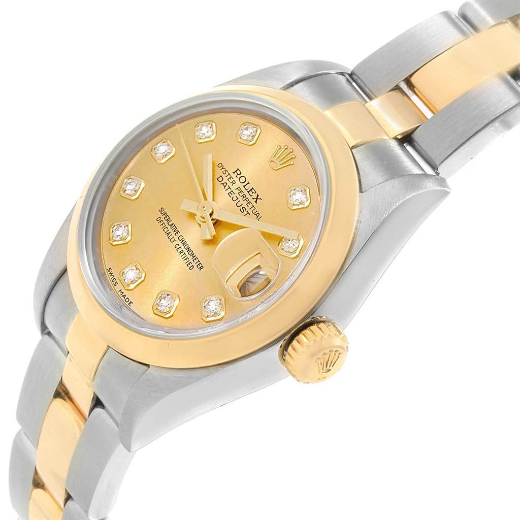 The Rolex Datejust 79163 Women's Steel and Gold (two tone) Champagne Dial 79163 Women's Steel and Gold (two tone) Champagne Dial watch is shown at a tilted angle, highlighting the dial, crown, and part of the bracelet.