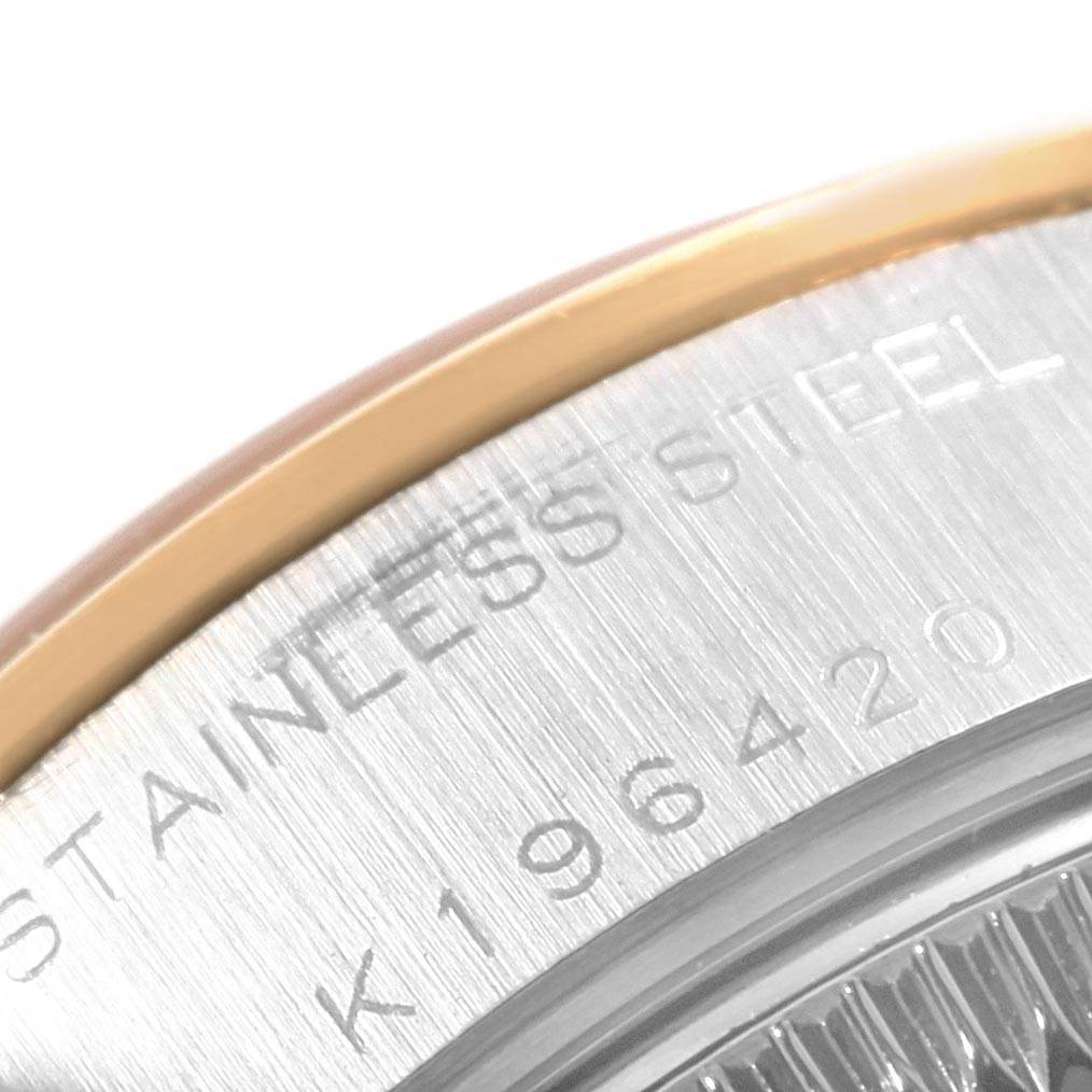 Close-up of the edge of a Rolex Datejust 79163 Women's Steel and Gold (two tone) Champagne Dial 79163 Women's Steel and Gold (two tone) Champagne Dial watch, showing the stainless steel and part of the engraved serial number.