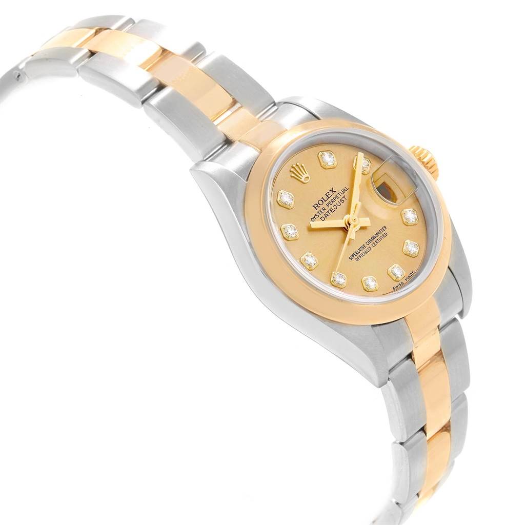 The Rolex Datejust 79163 Women's Steel and Gold (two tone) Champagne Dial 79163 Women's Steel and Gold (two tone) Champagne Dial watch is shown from a side angle, displaying its two-tone metal band and diamond-accented dial.