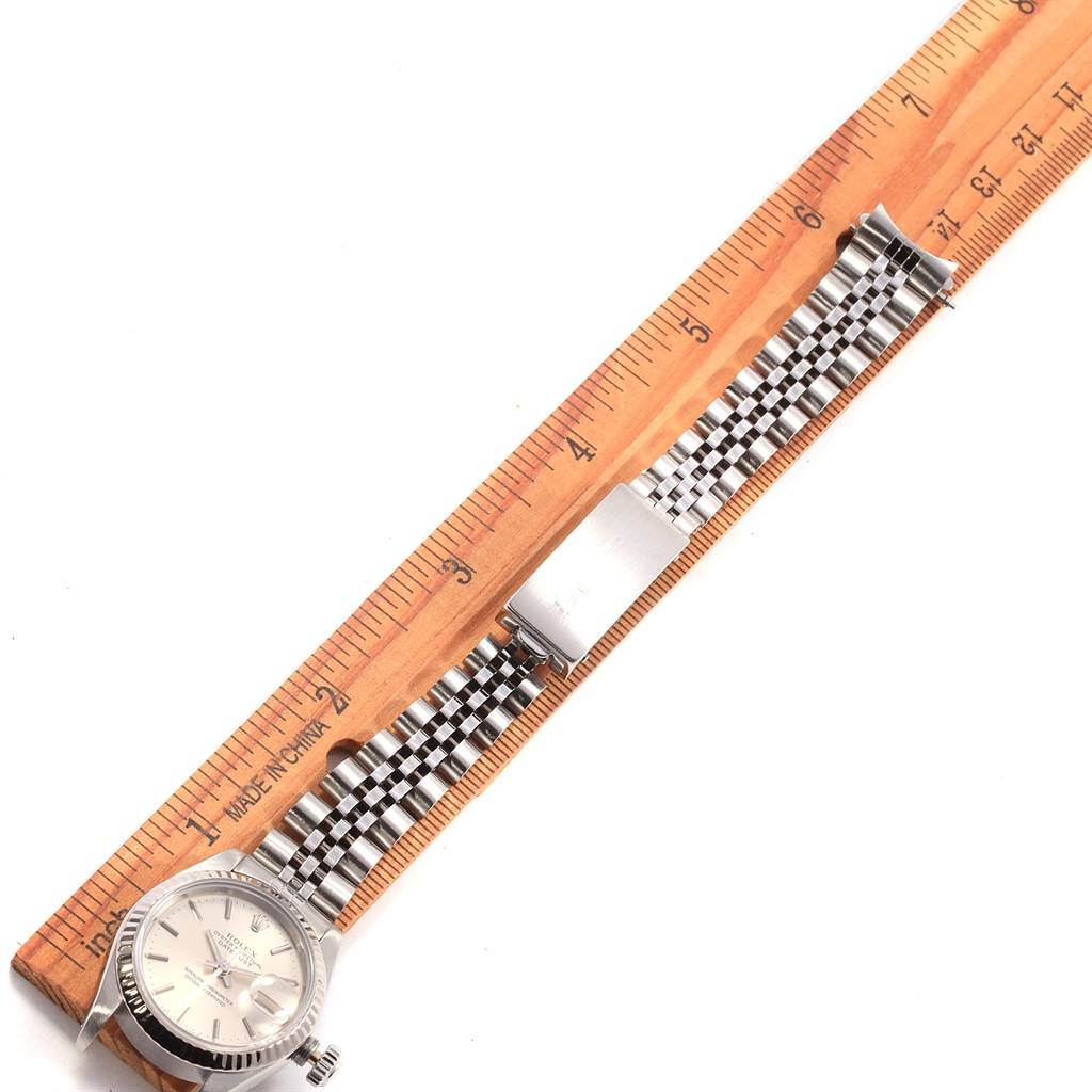 The image shows a Rolex Datejust 69174 Women's Stainless Steel Silver Dial 69174 Women's Stainless Steel Silver Dial watch laid flat next to a ruler, displaying its face and metal band at a top-down angle.
