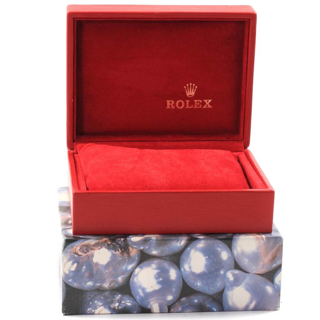 The image shows an open Rolex Datejust 69174 Women's Stainless Steel Blue Dial 69174 Women's Stainless Steel Blue Dial watch box with a red interior and pillowcase, and the Rolex logo inside the lid.